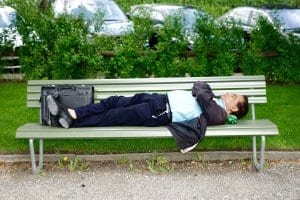 Man laying on a park bench
